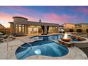 Resort-style pool and spa with fire feature create a relaxing backyard oasis at 2333 N 87Th Pl, Mesa, AZ 85207