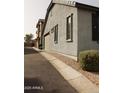 View of home showing stucco exterior, a side entry garage and manicured landscaping at 250 N Sandal --, Mesa, AZ 85205