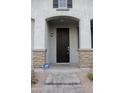 Close up of front door framed by stone accented columns and clean desert landscaping at 250 N Sandal --, Mesa, AZ 85205