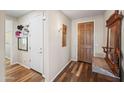 Welcoming entryway with hardwood floors, coat rack, and convenient access to a side door at 26336 W Tina Ln, Buckeye, AZ 85396