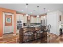 Modern kitchen with an island with a breakfast bar, sleek countertops and stainless steel appliances at 26336 W Tina Ln, Buckeye, AZ 85396