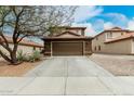 Two-story home featuring a two-car garage with a long driveway and desert landscaping at 31527 N Sundown N Dr, San Tan Valley, AZ 85143