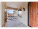 Inviting front porch with decorative railing and a solid wood front door at 3253 N 138Th Ave, Avondale, AZ 85392