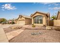 Charming single-story home featuring a three car garage and a well-manicured xeriscaped front yard at 3348 E Sequoia Dr, Phoenix, AZ 85050