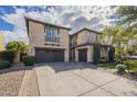 Spacious stucco home featuring multiple garages, a paved driveway, and mature landscaping at 4576 E Waterman St, Gilbert, AZ 85297