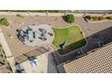 Aerial view of a landscaped backyard with a dining table and a section of green grass at 4610 S Hassett Cir, Mesa, AZ 85212