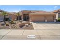 Charming single-story home with a well-maintained desert-landscaped front yard and a spacious three car garage at 4829 E Charleston Ave, Scottsdale, AZ 85254