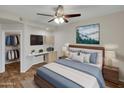 Cozy bedroom with a mounted TV, ceiling fan, and closet with an open doorway at 5303 N 7Th St # 134, Phoenix, AZ 85014