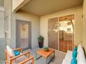 Relaxing patio with comfortable seating, a small wooden table, and sliding glass door at 5303 N 7Th St # 134, Phoenix, AZ 85014