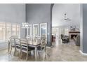 Open-concept dining room with large windows and views of a fireplace and sitting area at 5755 W Harrison St, Chandler, AZ 85226