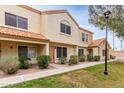 Charming two-story townhome with a traditional stucco exterior and a well-manicured front lawn at 5808 E Brown Rd # 42, Mesa, AZ 85205