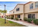 Charming two-story townhome with a traditional stucco exterior and a well-manicured front lawn at 5808 E Brown Rd # 42, Mesa, AZ 85205