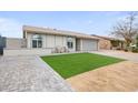 Lovely single-story home showcases a well-maintained lawn, a welcoming covered porch with seating, and an attached garage at 6225 W Mary Jane Ln, Glendale, AZ 85306