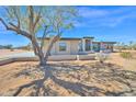 Modern desert home featuring clean lines and neutral tones in a spacious setting with mature tree at 7261 E Via Dona Rd, Scottsdale, AZ 85266