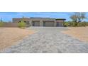 Attached three-car garage with modern doors and a spacious driveway at 7261 E Via Dona Rd, Scottsdale, AZ 85266