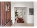 Inviting foyer with decorative rug, view to kitchen, and elegant front door at 7435 E Corrine Rd, Scottsdale, AZ 85260