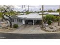 An aerial view of a charming single-story home featuring a covered parking area and desert landscaping at 8240 E Pueblo Ave, Mesa, AZ 85208