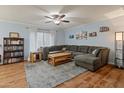 Spacious living room with a comfortable sectional sofa, wood-look floors, and good natural light at 8401 N 55Th Ave, Glendale, AZ 85302