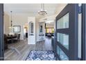 Welcoming foyer with high ceilings, modern chandelier, and open view to the dining and living spaces at 9032 E Larkspur Dr, Scottsdale, AZ 85260