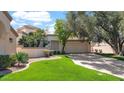 Single-Gathering home boasts lush green lawn, mature trees, and a spacious driveway leading to the two-car garage at 10421 N 100Th St, Scottsdale, AZ 85258