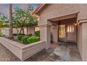 Inviting front entrance featuring a decorative door, manicured landscaping, and covered porch at 10563 E Bella Vista Dr, Scottsdale, AZ 85258