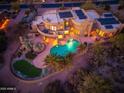 Aerial view of home with pool, putting green and solar panels, showcasing outdoor living at 10707 E Cottontail Ln, Scottsdale, AZ 85255