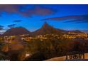 Scenic mountain views from rooftop terrace with outdoor seating at twilight at 10707 E Cottontail Ln, Scottsdale, AZ 85255