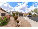 Charming single-story home with a desert landscaped front yard and two car garage at 11831 W Daley Ct, Sun City, AZ 85373