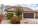 Charming single-story home with a well-manicured front yard with rock landscaping at 11831 W Daley Ct, Sun City, AZ 85373