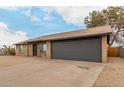 Single-story home with a two-car garage, desert landscaping, and a paved driveway on a sunny day at 1201 S 80Th St, Mesa, AZ 85209