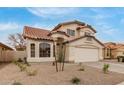 Charming two-story home with a 2-car garage and low maintenance front yard at 12629 W Cambridge Ave, Avondale, AZ 85392