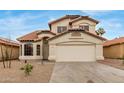 Two-story home with a well-manicured front yard and a two car garage at 12629 W Cambridge Ave, Avondale, AZ 85392