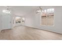 Bright living room with wood floors, white walls, and many windows at 12629 W Cambridge Ave, Avondale, AZ 85392