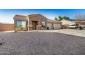 Single-story home featuring desert landscaping, a covered entryway, and a spacious three-car garage at 1294 W Chimes Tower Dr, Casa Grande, AZ 85122