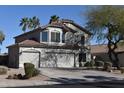 Two-story home with a three-car garage, desert landscaping, and mature palm trees at 1353 S Western Skies Dr, Gilbert, AZ 85296