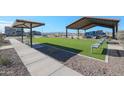 Lush turf with shaded seating areas and a playground make this a welcoming community space at 17322 W Jessie Ln, Surprise, AZ 85387