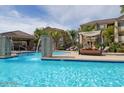 Resort-style pool area with cabana and waterfall feature at 18416 N Cave Creek Rd # 2063, Phoenix, AZ 85032