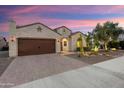 Charming single-story home boasts desert landscaping, a two-car garage, and an inviting entrance at 21854 N 263Rd Dr, Buckeye, AZ 85396