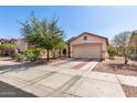 Single-story home featuring a two-car garage, desert landscaping, and a brick-lined driveway at 219 E Valley View Dr, Phoenix, AZ 85042