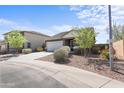 Charming single-story home with a well-manicured front yard and an attached two-car garage at 2355 E Rosario Mission Dr, Casa Grande, AZ 85194