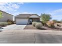 Charming single-story home with a well-manicured front yard and an attached two-car garage at 2355 E Rosario Mission Dr, Casa Grande, AZ 85194