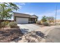 Charming single-story home with a well-manicured front yard and an attached two-car garage at 2355 E Rosario Mission Dr, Casa Grande, AZ 85194