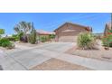 Charming desert home, complete with a two-car garage and easy-care landscaping at 2416 E Santiago Trl, Casa Grande, AZ 85194