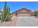 A charming desert home with a two-car garage and beautiful, low-maintenance landscaping at 2416 E Santiago Trl, Casa Grande, AZ 85194