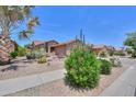 Beautiful desert landscaping in front of this single-story home creates excellent curb appeal in this arid climate at 2416 E Santiago Trl, Casa Grande, AZ 85194