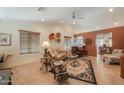 Inviting living room with tile floors, vaulted ceilings, and neutral color palette, creating a comfortable atmosphere at 2416 E Santiago Trl, Casa Grande, AZ 85194