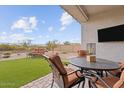 Relaxing backyard with artificial turf, outdoor seating, and a mounted television at 24275 N 173Rd Ave, Surprise, AZ 85387