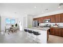 Bright kitchen with granite countertops, stainless steel appliances, and a dining area at 25286 N 156Th Ln, Surprise, AZ 85387