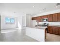 Bright kitchen boasts granite countertops, stainless steel appliances, and plenty of counter space at 25286 N 156Th Ln, Surprise, AZ 85387