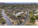 Aerial view of the house situated on a desert landscape with a view of the community and golf course at 3119 Arroyo Hondo --, Carefree, AZ 85377